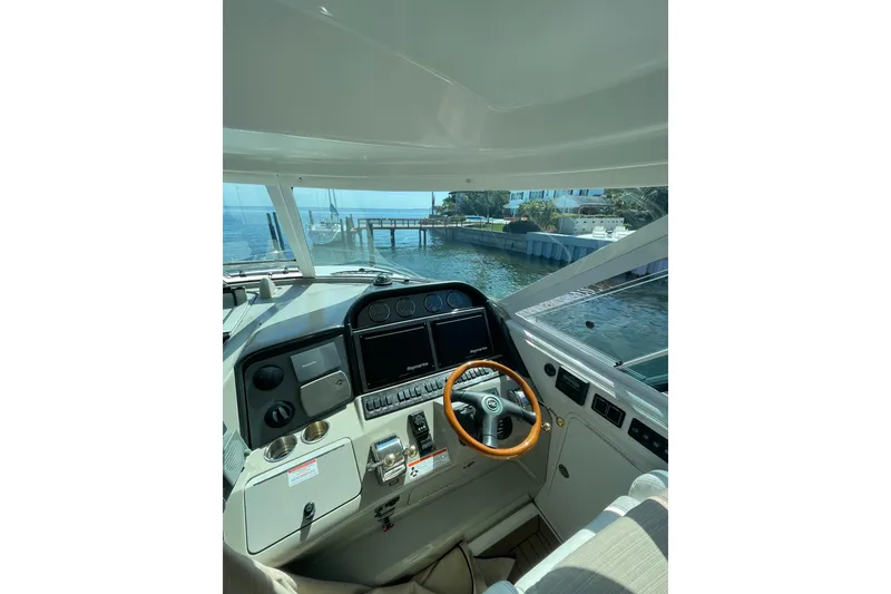 Slide: The Image of 2006 Sea Ray 40 Motor Yacht docked, featuring spacious deck and sleek design. - 6