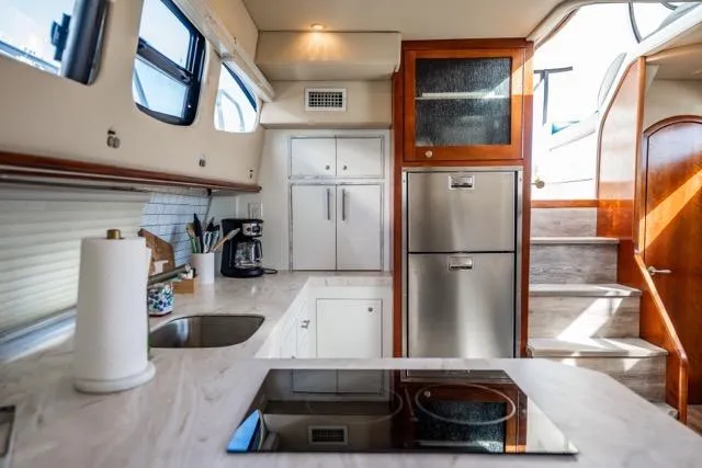 Slide: The Image of Modern kitchen interior of 2005 Cruiser Yachts 405 EXPRESS with sleek appliances and ample storage. - 10