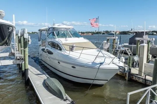 Slide: The Image of 2005 Cruiser Yachts 405 EXPRESS docked at marina with American flag. - 100