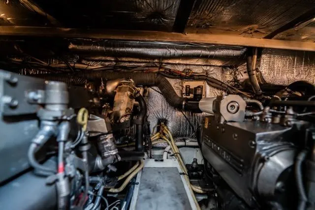 Slide: The Image of Engine room of 2005 Cruiser Yachts 405 EXPRESS, showcasing mechanical components and wiring. - 106