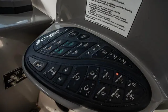 Slide: The Image of Control panel of a 2005 Cruiser Yachts 405 EXPRESS with various labeled buttons. - 112