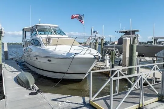 Slide: The Image of 2005 Cruiser Yachts 405 EXPRESS docked at marina with American flag. - 114