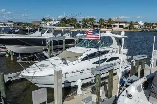 Slide: The Image of 2005 Cruiser Yachts 405 EXPRESS docked at marina with American flag. - 120