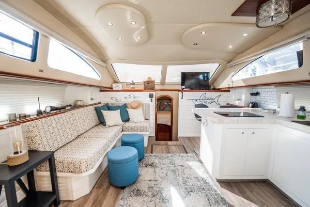 Slide: The Image of Luxurious interior of 2005 Cruiser Yachts 405 EXPRESS with modern seating and kitchen area. - 13