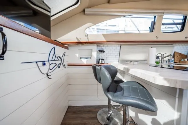 Slide: The Image of Interior of 2005 Cruiser Yachts 405 EXPRESS with modern seating and nautical decor. - 16