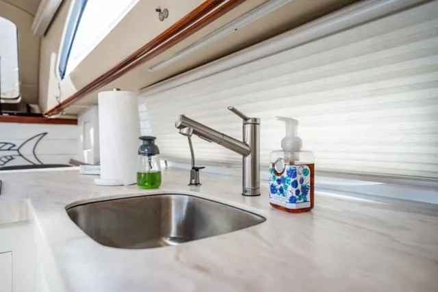 Slide: The Image of Modern kitchen sink area on 2005 Cruiser Yachts 405 EXPRESS with soap dispensers. - 17