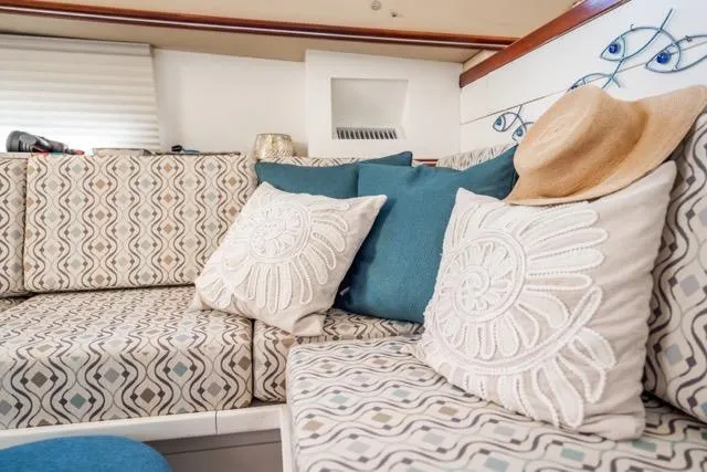 Slide: The Image of Luxurious interior of 2005 Cruiser Yachts 405 EXPRESS with patterned cushions and decorative pillows. - 18