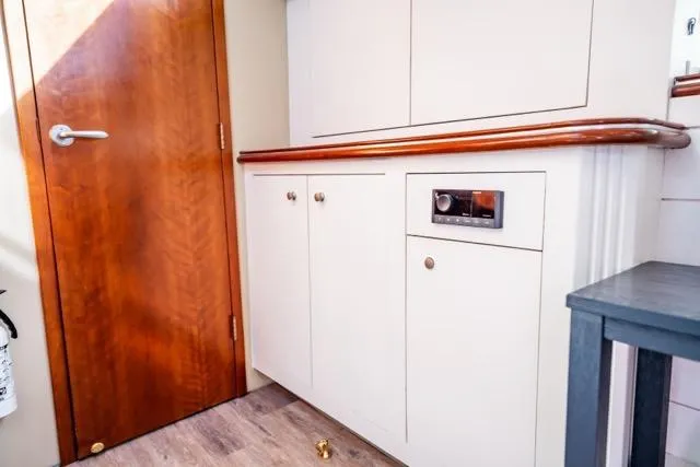 Slide: The Image of Interior of 2005 Cruiser Yachts 405 EXPRESS with wooden door and cabinetry. - 20