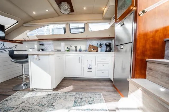 Slide: The Image of Luxurious 2005 Cruiser Yachts 405 EXPRESS kitchen interior with modern amenities and stylish design. - 23