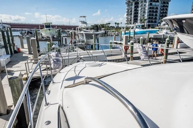 Slide: The Image of 2005 Cruiser Yachts 405 EXPRESS docked at marina with boats and waterfront buildings. - 26