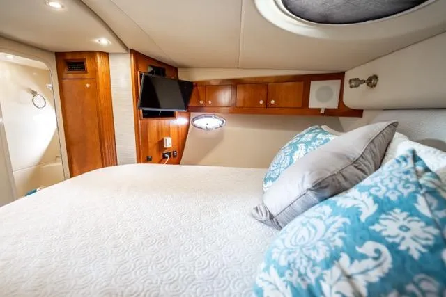 Slide: The Image of Luxurious cabin interior of 2005 Cruiser Yachts 405 EXPRESS with elegant bedding and wood accents. - 29
