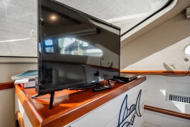 Slide: The Image of 2005 Cruiser Yachts 405 EXPRESS interior with TV and wooden accents. - 31