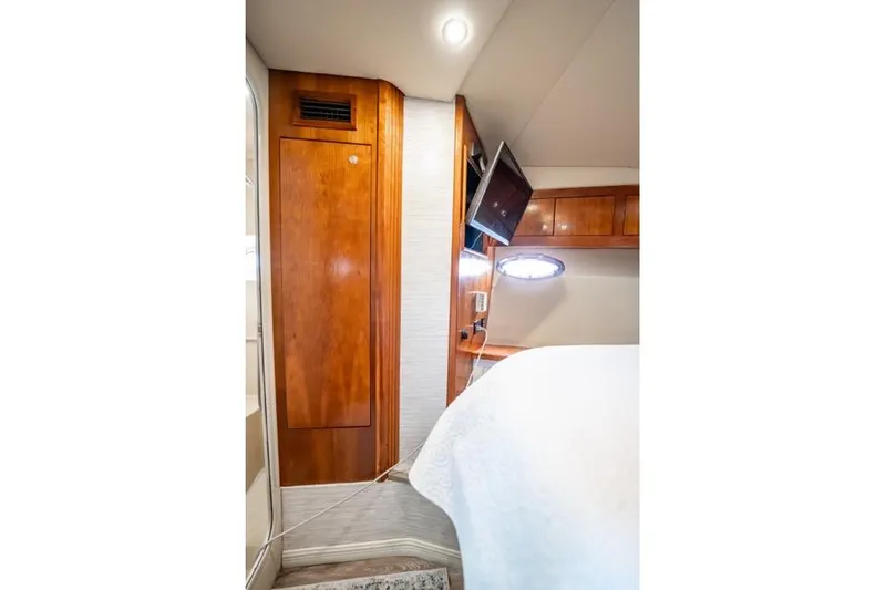 Slide: The Image of 2005 Cruiser Yachts 405 EXPRESS cabin interior with wood paneling and mounted TV. - 34