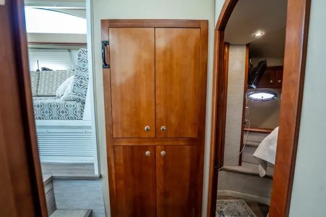 Slide: The Image of 2005 Cruiser Yachts 405 EXPRESS interior with wooden cabinetry and cozy bedroom. - 36