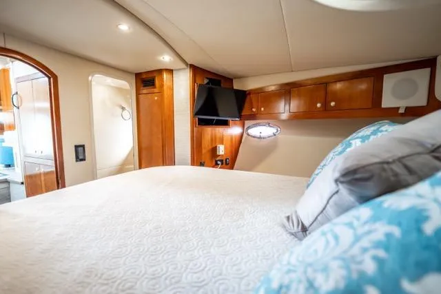 Slide: The Image of Luxurious 2005 Cruiser Yachts 405 EXPRESS cabin with elegant wood finishes and cozy bedding. - 37
