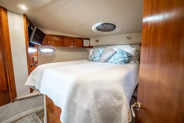 Slide: The Image of Luxurious cabin interior of 2005 Cruiser Yachts 405 EXPRESS with cozy bed and elegant wood finish. - 40