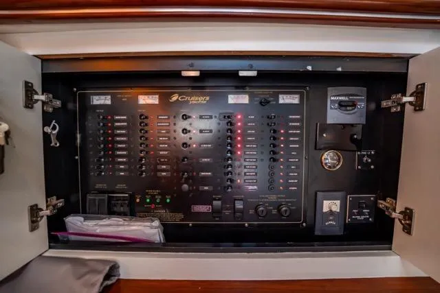 Slide: The Image of Electrical control panel of 2005 Cruiser Yachts 405 EXPRESS, featuring switches and gauges. - 41
