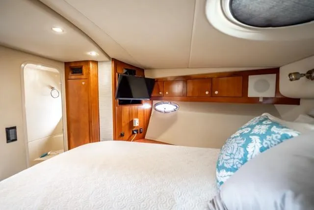 Slide: The Image of Luxurious cabin interior of 2005 Cruiser Yachts 405 EXPRESS with wood accents and cozy bedding. - 42