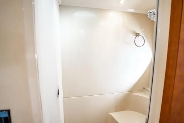 Slide: The Image of Bathroom interior of 2005 Cruiser Yachts 405 EXPRESS, featuring sleek white design. - 43