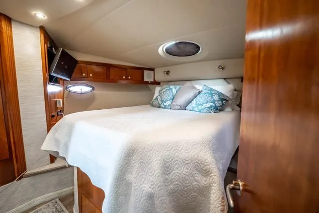 Slide: The Image of Luxurious bedroom interior of 2005 Cruiser Yachts 405 EXPRESS with cozy bedding and wood accents. - 44
