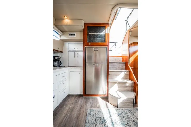 Slide: The Image of 2005 Cruiser Yachts 405 EXPRESS interior with modern kitchen and wooden stairs. - 5