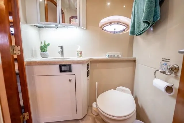 Slide: The Image of Luxurious bathroom in 2005 Cruiser Yachts 405 EXPRESS with modern fixtures and porthole window. - 51