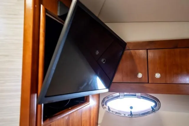 Slide: The Image of Interior of 2005 Cruiser Yachts 405 EXPRESS with TV and wooden cabinetry. - 56