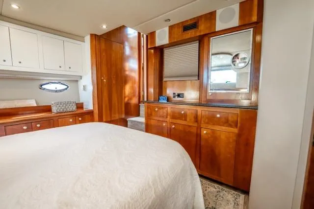 Slide: The Image of Luxurious 2005 Cruiser Yachts 405 EXPRESS cabin with elegant wood cabinetry and cozy bedding. - 57