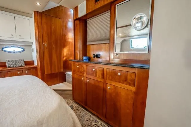 Slide: The Image of Luxurious 2005 Cruiser Yachts 405 EXPRESS cabin with wooden cabinetry and elegant decor. - 58