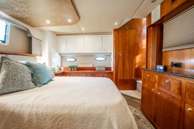 Slide: The Image of Luxurious cabin interior of 2005 Cruiser Yachts 405 EXPRESS with elegant wood finishes. - 59