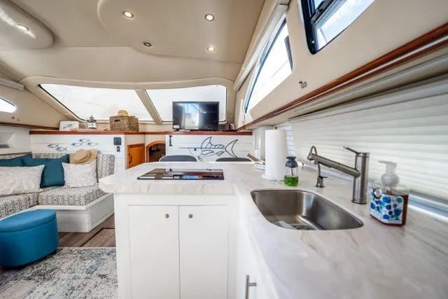 Slide: The Image of Luxurious interior of 2005 Cruiser Yachts 405 EXPRESS with modern kitchen and cozy seating area. - 6