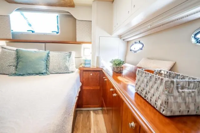 Slide: The Image of Luxurious 2005 Cruiser Yachts 405 EXPRESS cabin with elegant wood finishes and cozy bedding. - 61