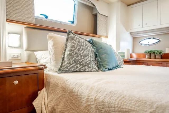 Slide: The Image of Luxurious cabin interior of 2005 Cruiser Yachts 405 EXPRESS with elegant bedding and decor. - 64