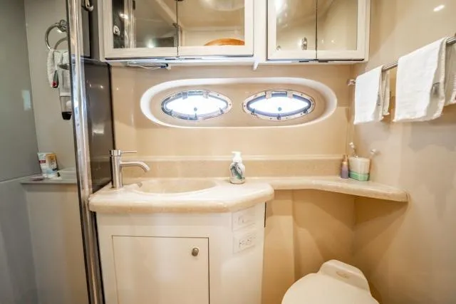 Slide: The Image of Luxurious bathroom in 2005 Cruiser Yachts 405 EXPRESS with modern fixtures and porthole windows. - 68