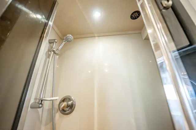 Slide: The Image of Shower area inside 2005 Cruiser Yachts 405 EXPRESS, featuring modern fixtures and lighting. - 69
