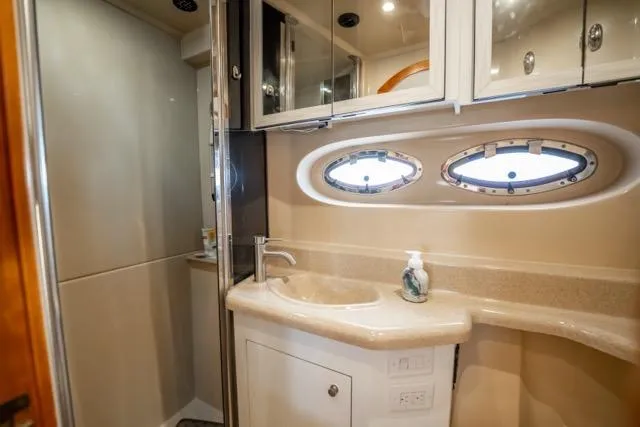 Slide: The Image of Luxurious bathroom in 2005 Cruiser Yachts 405 EXPRESS with oval windows and modern fixtures. - 70