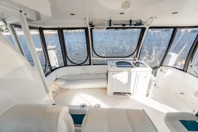 Slide: The Image of 2005 Cruiser Yachts 405 EXPRESS interior with seating and kitchenette, overlooking water. - 73