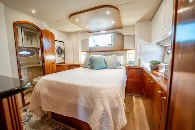 Slide: The Image of Luxurious 2005 Cruiser Yachts 405 EXPRESS cabin with elegant wood finishes and cozy bedding. - 74