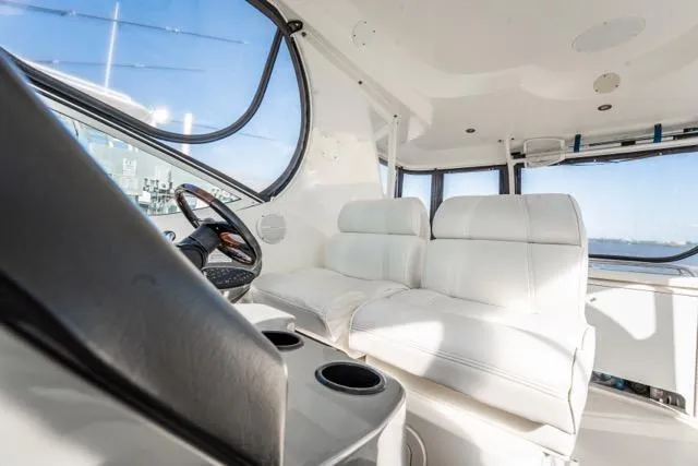 Slide: The Image of 2005 Cruiser Yachts 405 EXPRESS interior with white seating and steering wheel. - 78