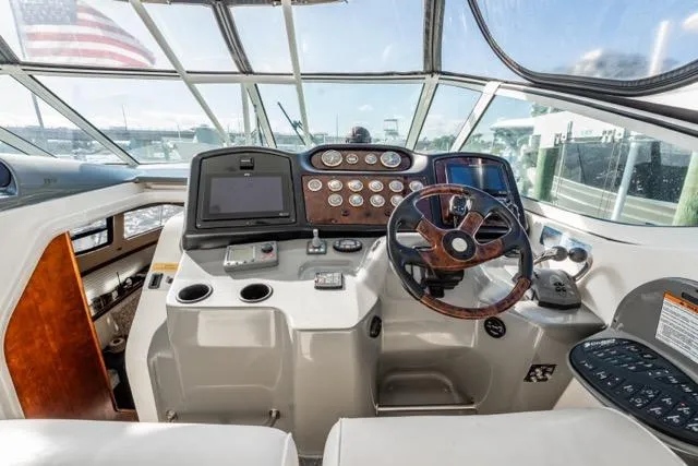 Slide: The Image of 2005 Cruiser Yachts 405 EXPRESS helm with modern navigation controls and panoramic view. - 80