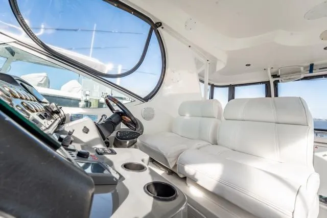 Slide: The Image of 2005 Cruiser Yachts 405 EXPRESS interior with white seating and control panel. - 83