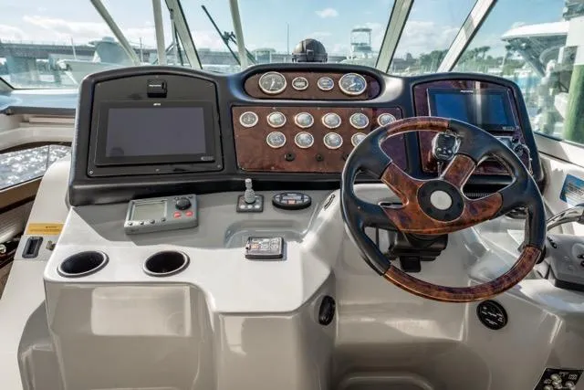 Slide: The Image of Helm of 2005 Cruiser Yachts 405 EXPRESS with modern navigation controls and steering wheel. - 84