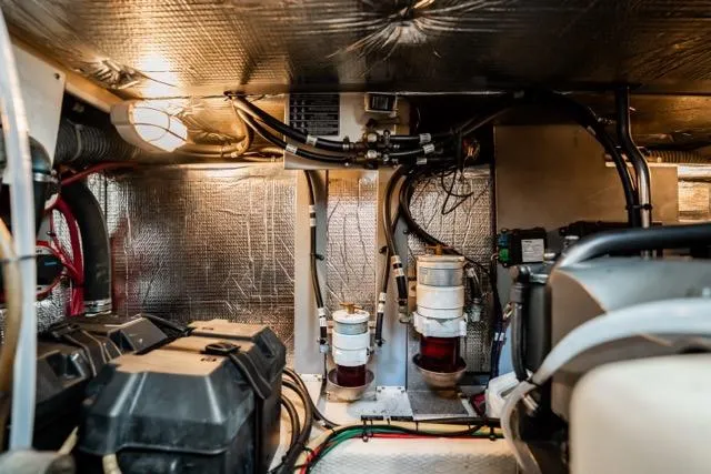 Slide: The Image of Engine room of 2005 Cruiser Yachts 405 EXPRESS, showcasing mechanical components and wiring. - 85