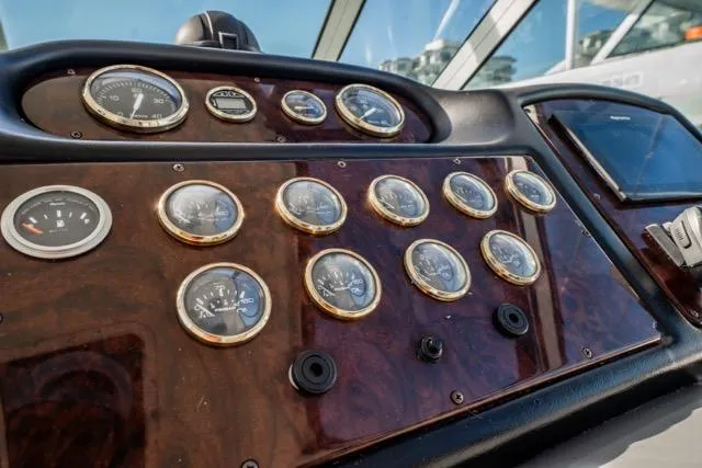 Slide: The Image of Dashboard of 2005 Cruiser Yachts 405 EXPRESS with multiple gauges and controls. - 86