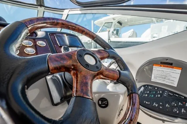 Slide: The Image of Steering wheel and dashboard of 2005 Cruiser Yachts 405 EXPRESS boat. - 87