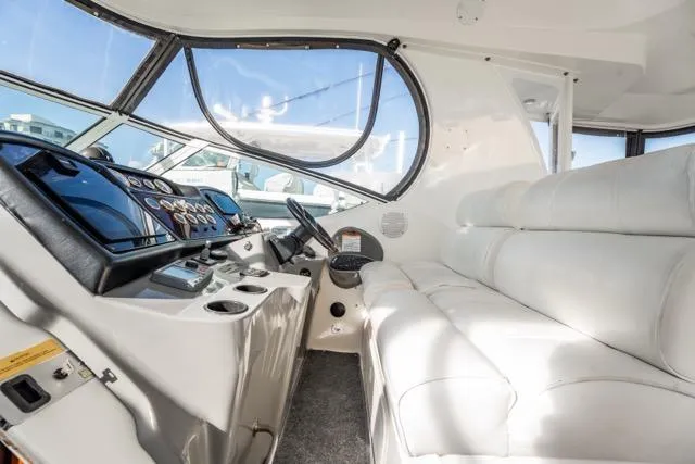 Slide: The Image of Interior of 2005 Cruiser Yachts 405 EXPRESS with white seating and control panel. - 88