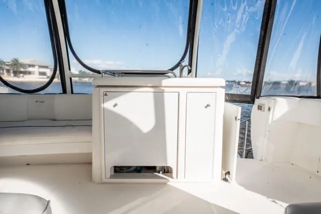 Slide: The Image of 2005 Cruiser Yachts 405 EXPRESS interior with white cabinetry and panoramic windows. - 90