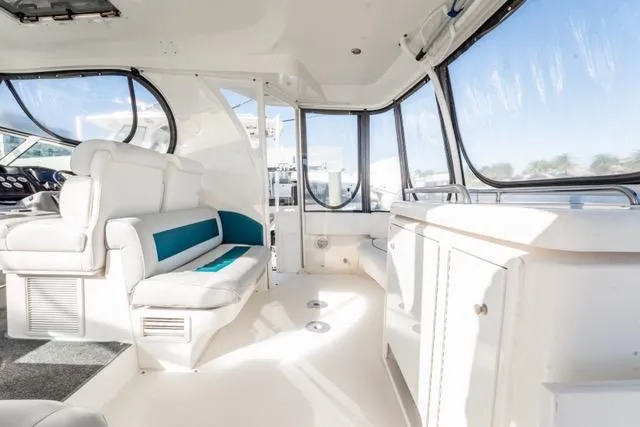 Slide: The Image of 2005 Cruiser Yachts 405 EXPRESS interior with white seating and panoramic windows. - 92