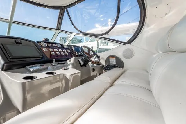 Slide: The Image of 2005 Cruiser Yachts 405 EXPRESS helm with leather seating and modern dashboard controls. - 93