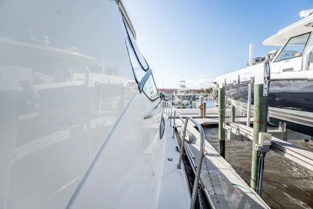 Slide: The Image of 2005 Cruiser Yachts 405 EXPRESS docked at marina under clear blue sky. - 94